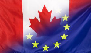 Canada and European Union relations concept with diagonally merged real fabric flags